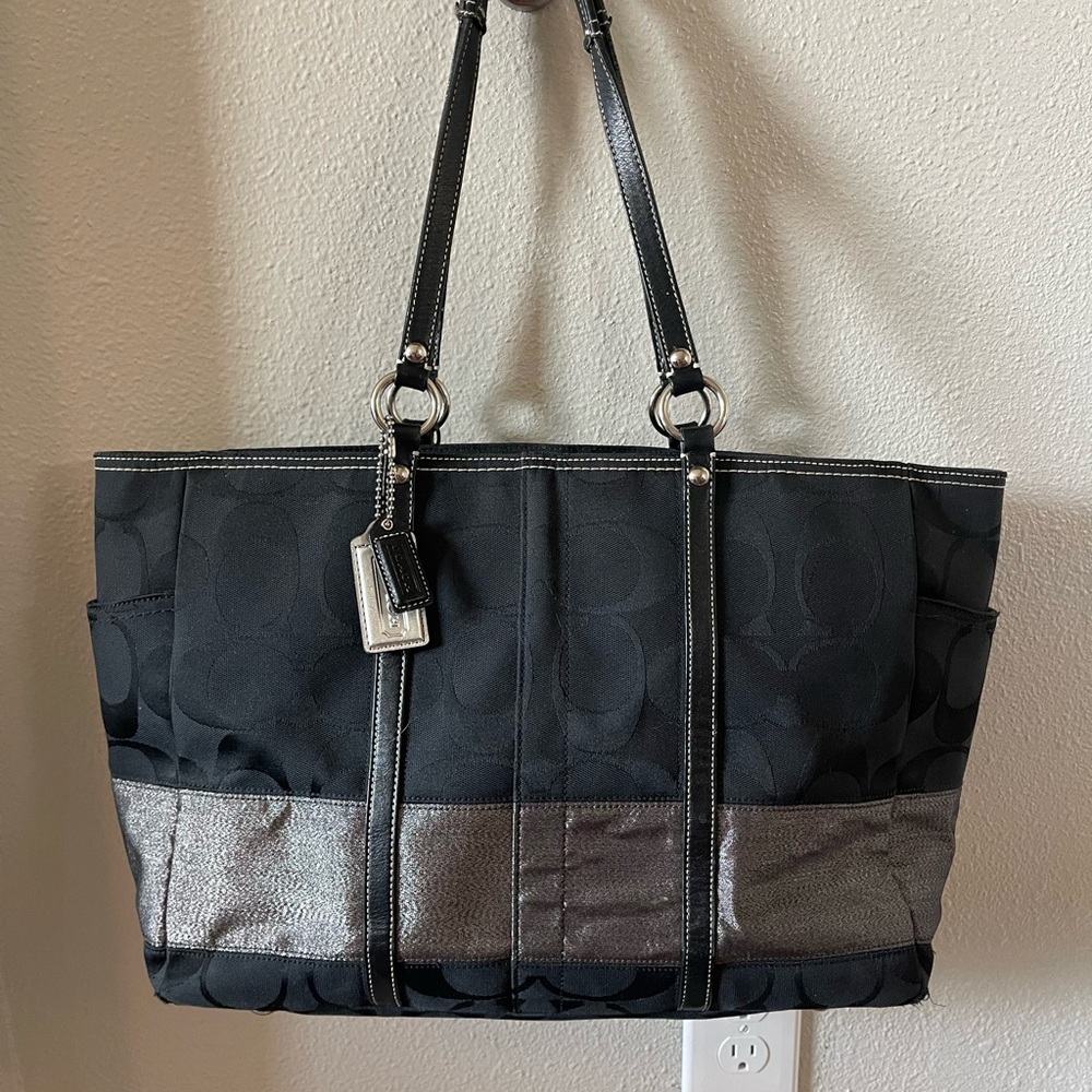 Black and silver Coach signature tote bag/diaper bag with lots of pockets.